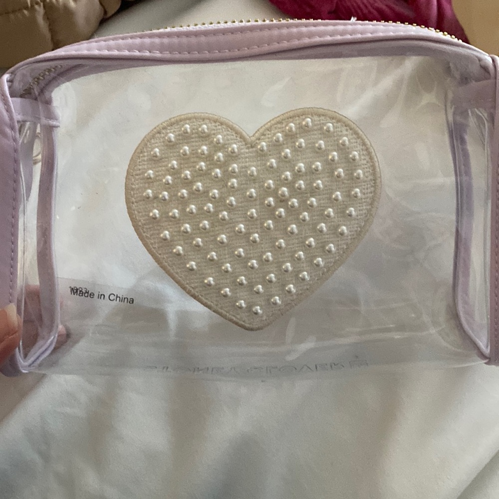 Stoney Clover Lane clear pouch with jumbo pearl heart patch sewn on the front.